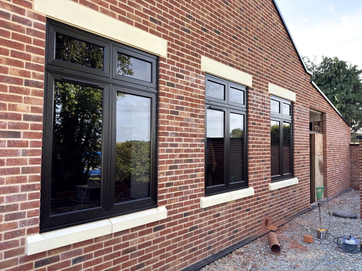 Black flush casement PVCu windows with anti-sun solar control glass and blackout glass in the top lights fitted in Halvergate Norfolk – replacement windows Great Yarmouth Acle